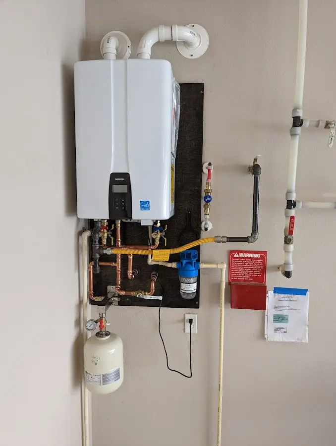 Professional plumber installing copper piping in a Davidson home